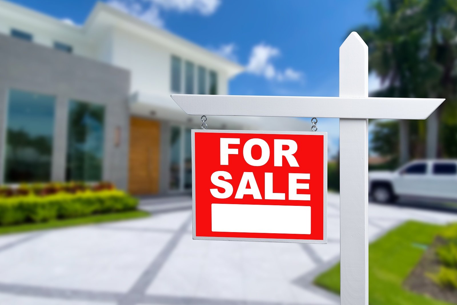 Home For Sale Real Estate Sign and Beautiful New House